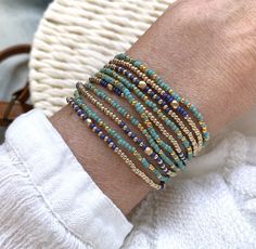 Beautiful Bohemian and colourful set of two wrap bracelets, both bracelets are handstrung on strong elastic cord and each wraps 5 times., also suitable to wear as a long necklace.  M A T E R I A L * Seed beads : gold plated ( 24 kt), turquoise, cobalt blue, champagne gold  seed beads * Extra strong elastic S I Z E * Size medium, 86 cm / 34 inch ( 17cm/6.8 inch when wrapped), fits the normal to small waist.  * Please sent me a message for other sizes, these bracelets can be made in any lenght (see faq for meas  S H I P P I N G  *  All orders are wrapped as a gift and shipped safely in a small letter box *  All orders above € 35 have free standard priority shipping (untracked) all orders above  € 150      will be upgraded to free  priority shipping with track  All jewelry in my shop is handm Turquoise Multi-strand Wrap Bracelet As Gift, Bohemian Wrap Bracelet With Tiny Beads As A Gift, Bohemian Wrap Bracelet With Tiny Beads Gift, Green Multi-strand Wrap Bracelet As Gift, Bohemian Stackable Wrap Bracelet As Gift, Handmade Flexible Friendship Bracelets As Gift, Handmade Friendship Bracelets As Gift, Colorful Beads Multi-strand Wrap Bracelet As Gift, Colorful Multi-strand Wrap Bracelet As Gift