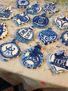 blue and white decorated cookies sitting on top of a table