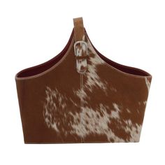 a brown and white cow print purse