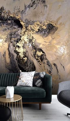 a living room scene with focus on the couch and wallpaper that looks like an abstract painting