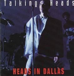 a man standing in front of a microphone on top of a cover with the words talking heads