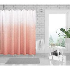 a bathroom with a pink shower curtain next to a white bath tub