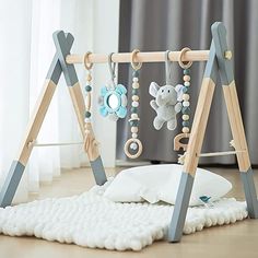 a baby's play gym with toys hanging from it