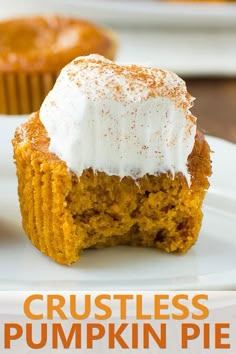 three pumpkin cupcakes on a white plate with frosting and powdered sugar