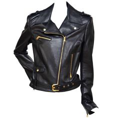 Versace black Leather Biker Jacket. Black leather epaulettes, studded lapels, zipped cuffs, two zipped front pockets, front flap pocket, fully lined exposed asymmetric zip fastening through front 100% leather (lamb); lining: 96% rayon, 4% elastane specialist clean. Gold tone hardware. Size 42.New without tags.Never worn with some tiny lines on the sleeves from trying on. Made in Italy. Approximate measurements: Length back 21" Underarm 34" Waist 31" Sleeve 24" FINAL SALE. Versace Jacket, Biker Leather Jacket, Green Leather Jackets, Moto Biker Jacket, Black Leather Biker Jacket, Jackets Black, Fantasy Wardrobe, Studded Jacket