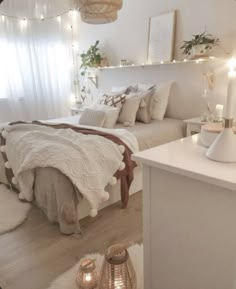 a bedroom with white walls and lights on the headboard, bed in foreground