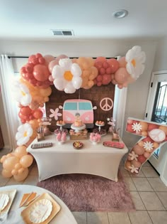 a table topped with balloons and decorations