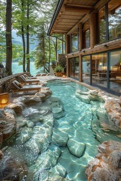 an outdoor swimming pool surrounded by rocks and trees