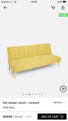 a yellow couch sitting on top of a white floor next to a green sign that says,