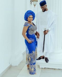 a man and woman dressed in traditional african clothing