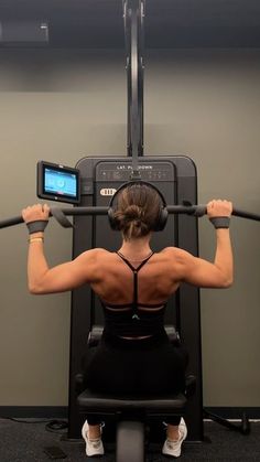 a woman is doing exercises on a machine