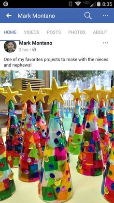 a group of colorful christmas trees sitting on top of a table