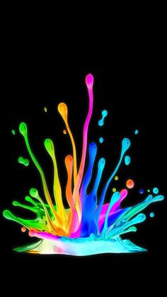 colorful paint splashing into the black background