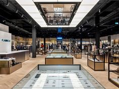 a store filled with lots of different types of shoes and accessories in glass cases on display