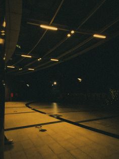 an empty parking garage at night with lights shining on the floor and in the ceiling