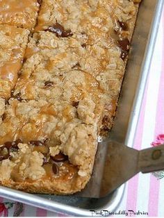 an oatmeal cookie bar in a pan with a spatula