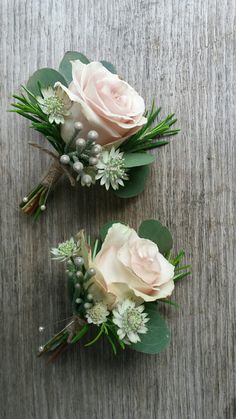 two boutonnieres with pink roses and greenery