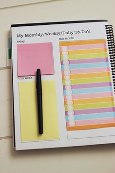 a notepad and pen on top of a planner with the words, my month / weekly / daily to - do's