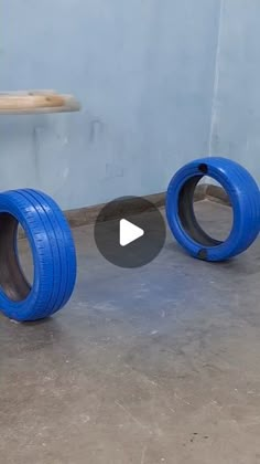 two blue tires sitting next to each other on the ground