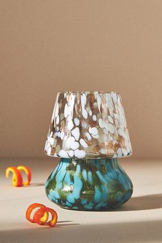 a glass lamp shade sitting on top of a table next to gummy candies