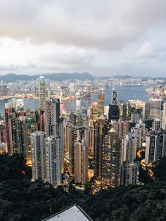 an aerial view of the city lights and skyscrapers in hong kong, china's financial district