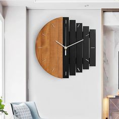 a clock that is on the side of a wall next to a couch in a living room