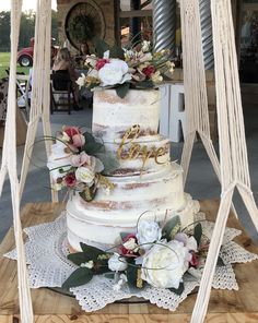 a white wedding cake with flowers on top