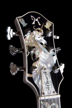 the neck of an electric guitar that is decorated with images