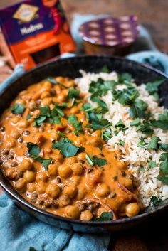 a bowl filled with rice, beans and cilantro on top of a table