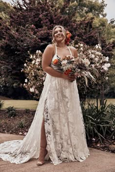 a woman in a white dress holding flowers