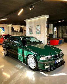 a green car is parked in a garage