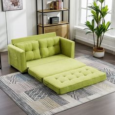 a green couch sitting on top of a rug in a living room