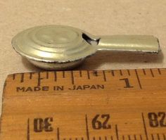 a measuring tape is next to a metal object that has been made in japan on it