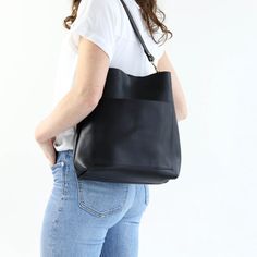 "This perfectly sized, perfectly casual black leather hobo bag will easily become your favorite everyday bag! The front pocket keeps your cell phone handy, and the magnetic snap closure and inside slip pocket keep all your essentials secured inside. Handmade from luxurious vegetable tanned leather, and solid brass hardware, it will break in beautifully and age gracefully! The buttery vegetable tanned leather will only look better and better with time and wear, plus you can add a gold foil monogr Cross Body Leather Bag, Black Leather Hobo Bag, Handmade Leather Tote Bag, Handmade Leather Tote, Bag Minimalist, Age Gracefully, Black Leather Shoulder Bag, Minimalist Bag, Beige Bag