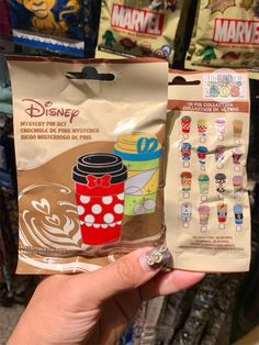 someone holding up a bag of disney pins