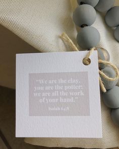 there is a card with a quote on it next to some beads and a string