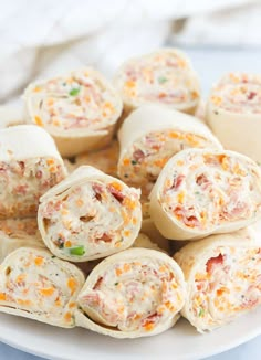 there are many rolls with different toppings on the top one is filled with meat and cheese