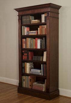 a tall bookcase with many books on it