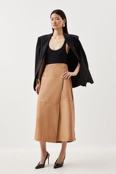 Experience Updated Wardrobe Essentials With Our Midi Skirt, Made In Sleek Faux Leather, Featuring A Flared Silhouette And A High Waistline, Creating A Universally Flattering Fit. With A Statement Wrap Style, This Piece Can Be Styled With With Anything To Create A Look With Impact, From A Blouse And Strappy Heels, To A Knit Jumper, Tights, And Boots. Faux Leather Tie Detail Wrap Midi Skirt High Quality Faux Leather Fabric Statement Wrap Style Comfortable High Waistline Flattering Full Silhouette Wrap Midi Skirt, Midi Skirt Outfit, Lace Sleeve Top, Striped Midi Skirt, Leather Tie, Linen Shirt Dress, Faux Leather Fabric, Stripe Skirt, Karen Millen