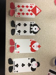 four playing cards are laid out on the table to be used as an ornament