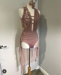 a mannequin wearing a pink dress with flowers on it's back and neck