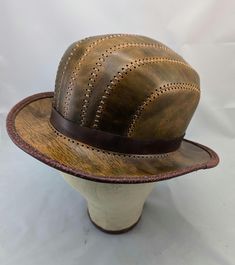 Handmade and hand stitched leather bowler hat is sized at 22.5 inches on the inside with a little stretch.  If you have any questions please message before purchase. Handmade Brown Brimmed Hat, Leather Bowler Hat, Brown Leather Top Hat With Curved Brim, Luxury Brown Leather Top Hat, Vintage Brown Leather Brimmed Hat, Bowler Hat, Stitching Leather, Hat Sizes, Hand Stitching