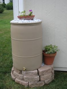 a water tank sitting next to a potted plant