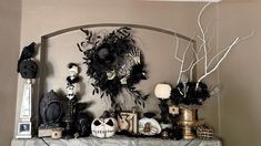 a mantle decorated with halloween decorations and skulls