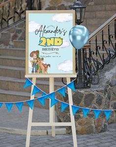 a blue balloon is in the air next to a sign that says,'2nd birthday '