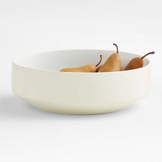 two pears in a white bowl on a white background