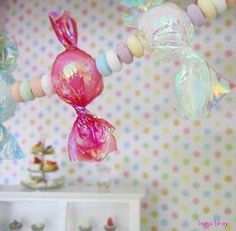 there are many candy decorations hanging from the ceiling