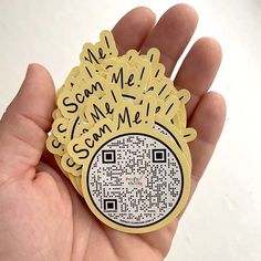 someone is holding up a qr - code sticker that says, we scan me with someone else