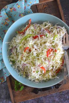 a blue bowl filled with coleslaw slaw