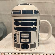 a star wars themed coffee mug sitting on top of a wooden table